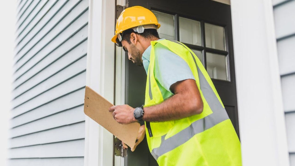 man-wearing-construction-vest-holding-clipboard.jpeg