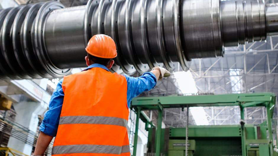 Man working near machinery wearing high visibility safety apparel