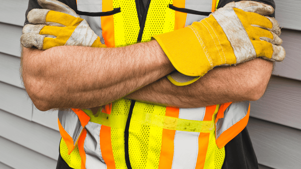 two-women-wearing-safety-vest-and-safety-helmet-talking-to-each-other